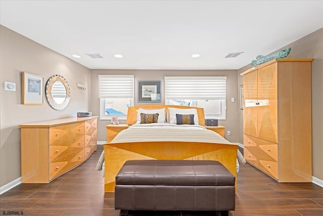 bedroom featuring dark hardwood / wood-style floors and multiple windows