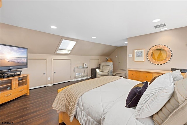 bedroom featuring dark hardwood / wood-style floors and lofted ceiling with skylight