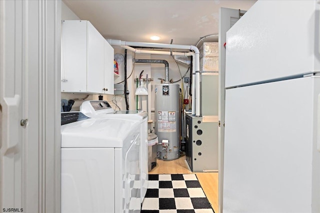 laundry area with cabinets, gas water heater, washer and clothes dryer, and light hardwood / wood-style floors