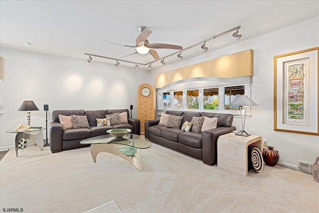 carpeted living room featuring ceiling fan