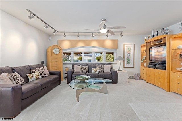 carpeted living room featuring rail lighting and ceiling fan