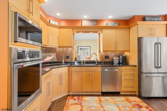 kitchen with tasteful backsplash, light brown cabinets, dark hardwood / wood-style floors, and appliances with stainless steel finishes