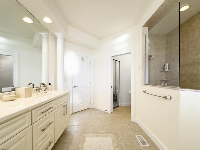 bathroom featuring vanity, tile patterned flooring, decorative columns, and a tile shower