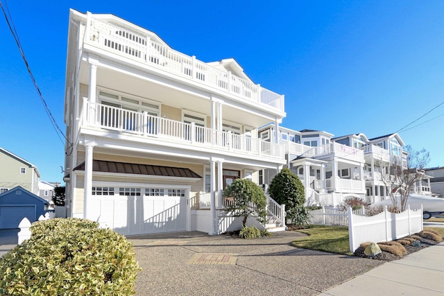 view of front facade featuring a garage and a balcony