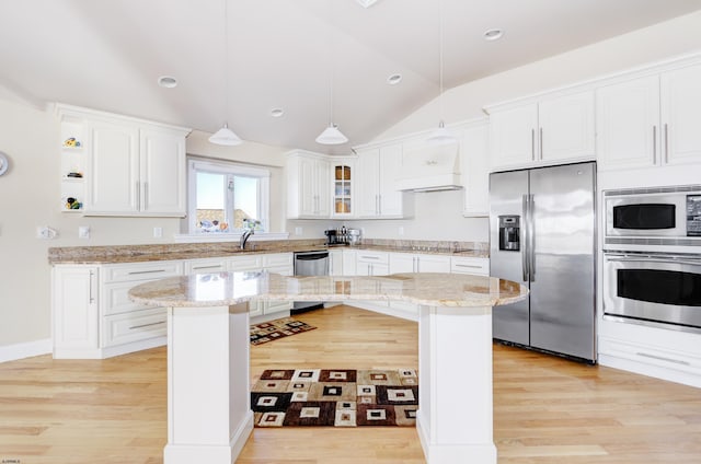 kitchen featuring stainless steel appliances, decorative light fixtures, a kitchen island, and white cabinets