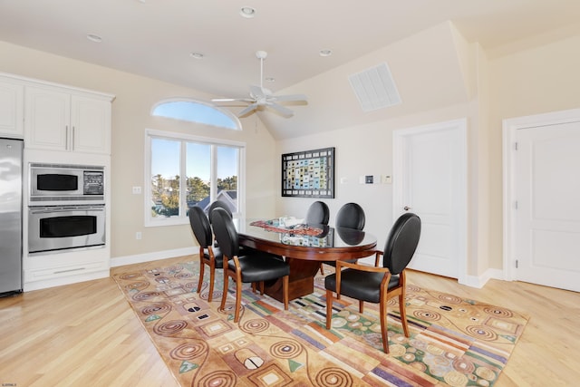 dining room featuring ceiling fan, lofted ceiling, and light hardwood / wood-style floors