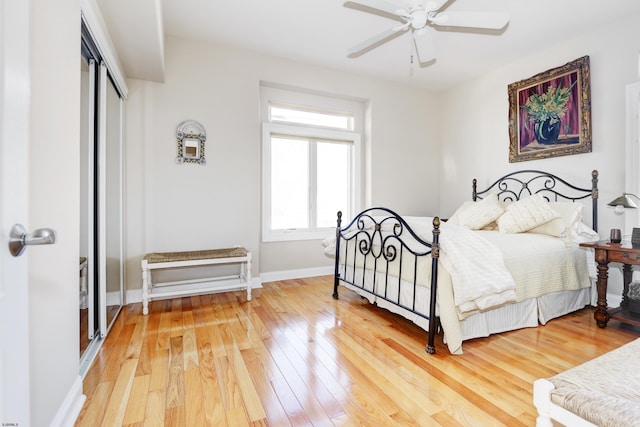 bedroom with ceiling fan, hardwood / wood-style floors, and a closet