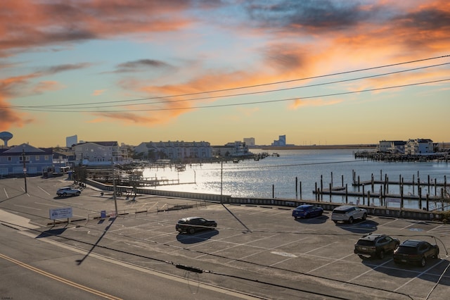 patio terrace at dusk with a water view and a boat dock