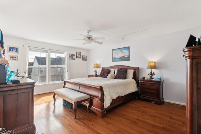 bedroom with hardwood / wood-style flooring, track lighting, and ceiling fan