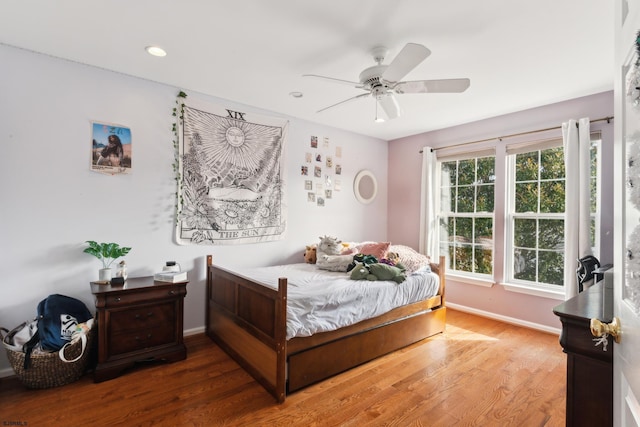 bedroom with wood-type flooring and ceiling fan