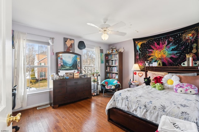 bedroom with ceiling fan, light hardwood / wood-style floors, and multiple windows