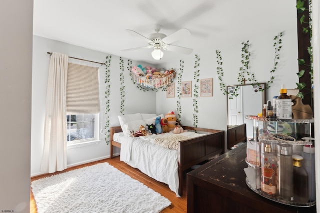 bedroom with hardwood / wood-style flooring and ceiling fan