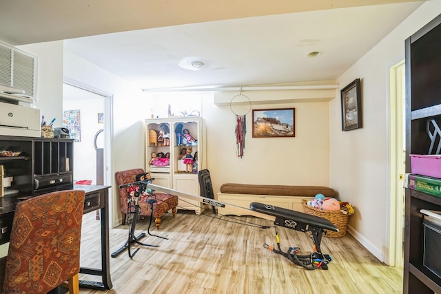 exercise area featuring light hardwood / wood-style flooring