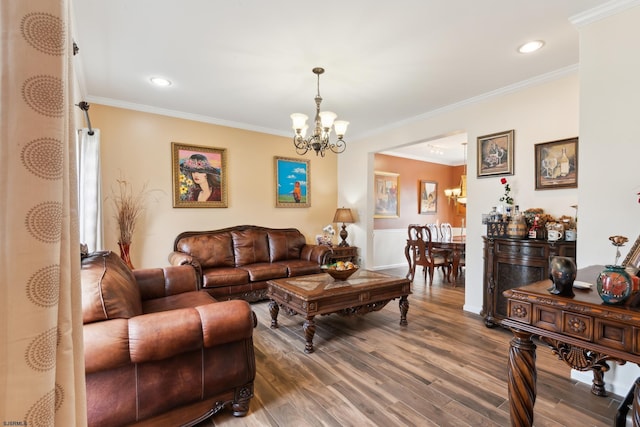 living room with crown molding, wood-type flooring, and a chandelier