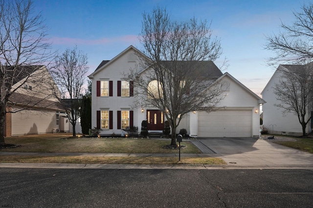 view of front facade with a garage and a lawn