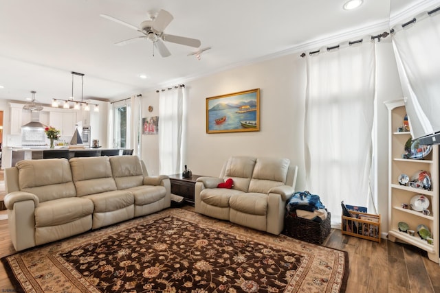 living room featuring crown molding, ceiling fan, and hardwood / wood-style floors