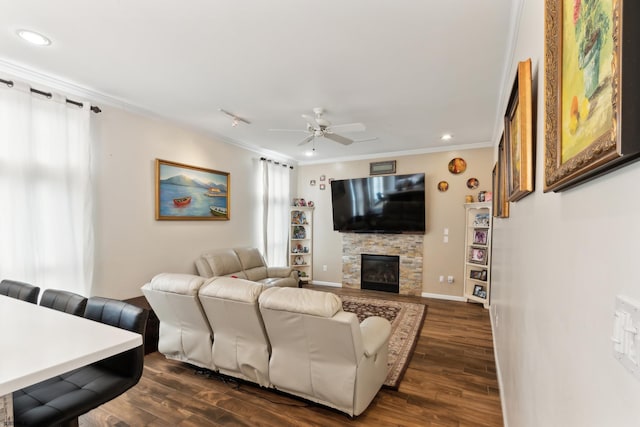 living room featuring crown molding, a fireplace, dark hardwood / wood-style floors, and ceiling fan