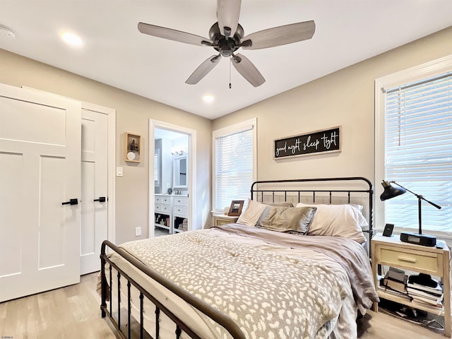 bedroom with multiple windows, light hardwood / wood-style flooring, and ceiling fan