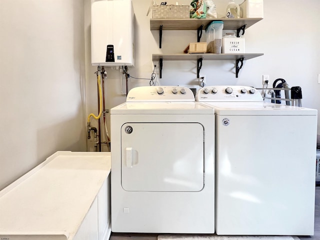 clothes washing area with independent washer and dryer and water heater