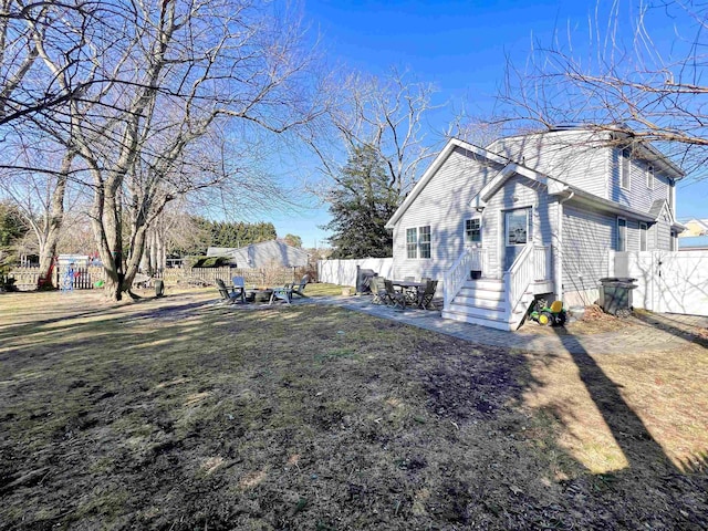 view of home's exterior with a patio area and a lawn