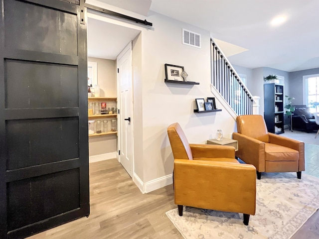 interior space featuring light hardwood / wood-style floors and a barn door