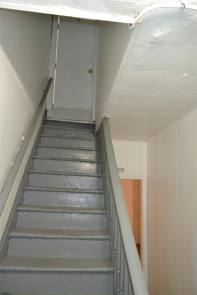 stairs with wood walls