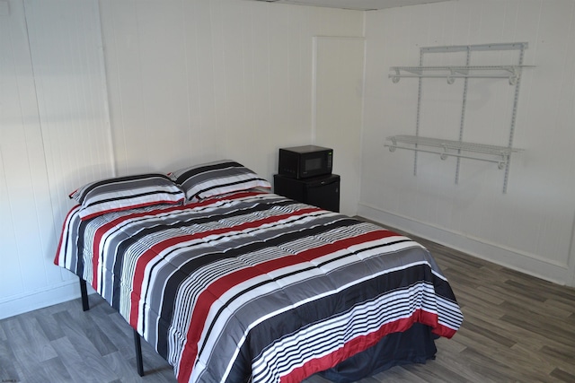 bedroom with dark hardwood / wood-style floors