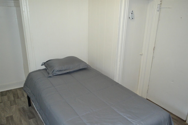 bedroom with dark wood-type flooring