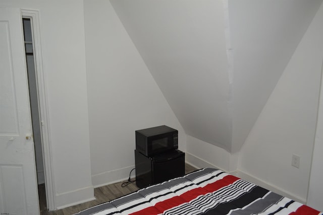 bedroom with dark wood-type flooring