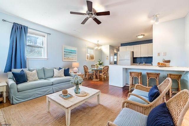 living room with ceiling fan and dark hardwood / wood-style floors