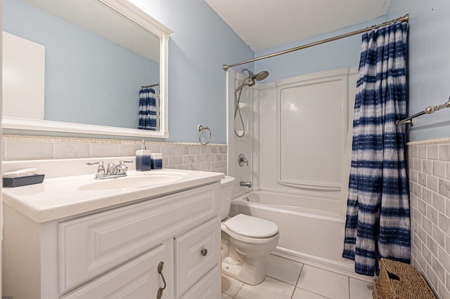 full bathroom with shower / tub combo with curtain, tile walls, vanity, tile patterned floors, and toilet