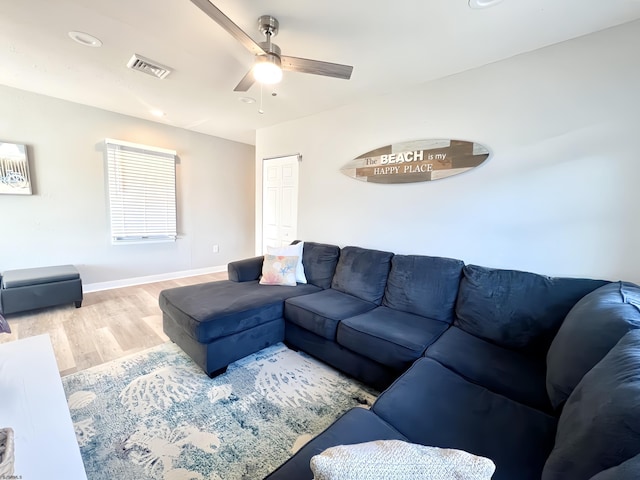 living room with hardwood / wood-style flooring and ceiling fan