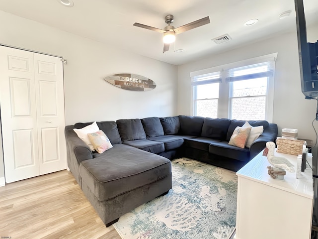 living room featuring ceiling fan and light wood-type flooring