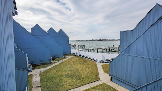 exterior space with a water view and a boat dock