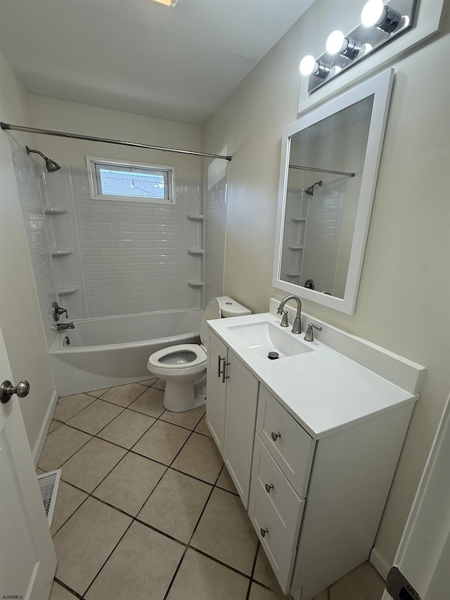 full bathroom with tile patterned flooring, vanity, tiled shower / bath combo, and toilet