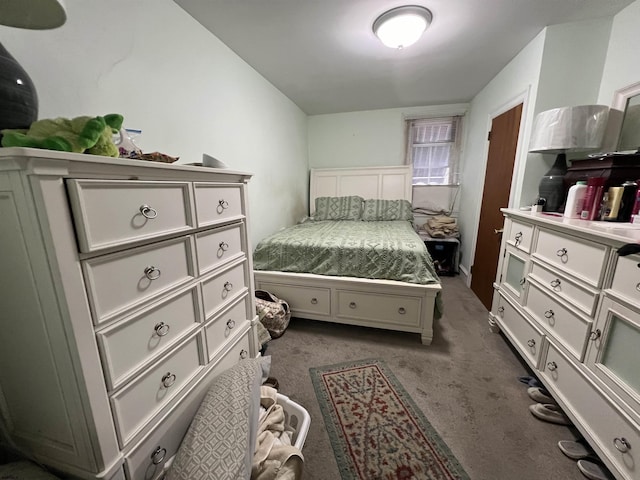 bedroom with dark colored carpet