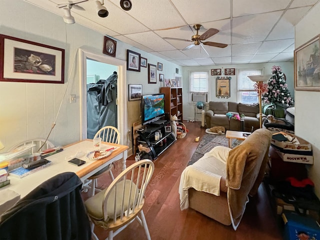 living room featuring a paneled ceiling, dark hardwood / wood-style floors, and ceiling fan