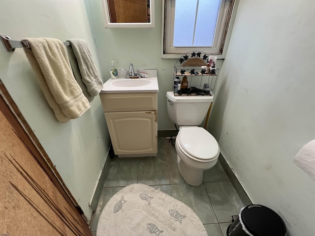 bathroom with vanity, tile patterned floors, and toilet