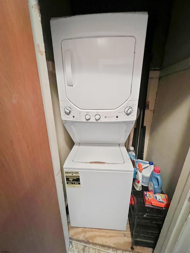 laundry area with stacked washer and clothes dryer