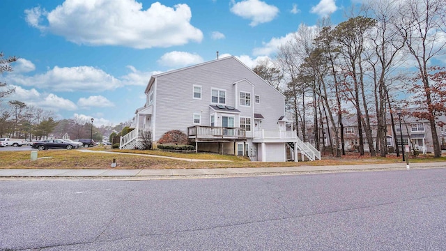 view of property with a front yard and a deck