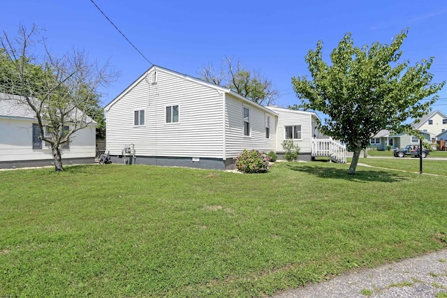 view of property exterior with a yard