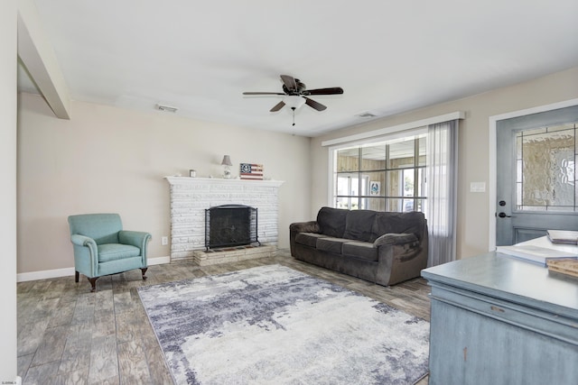 living room featuring hardwood / wood-style floors and ceiling fan