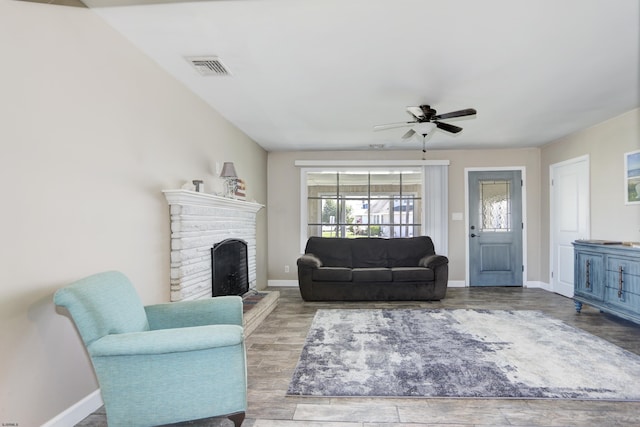 living room with light hardwood / wood-style flooring and ceiling fan