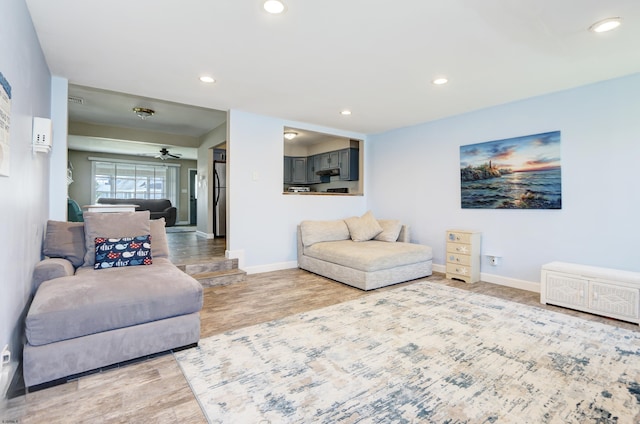 living room with wood-type flooring and ceiling fan