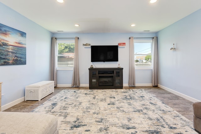 unfurnished living room with hardwood / wood-style flooring and plenty of natural light