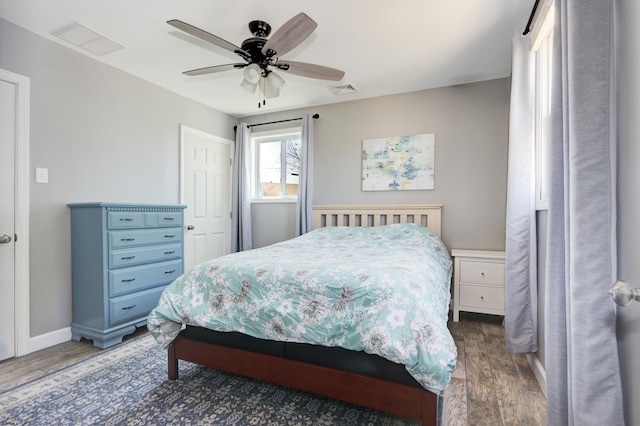 bedroom with ceiling fan and dark hardwood / wood-style flooring