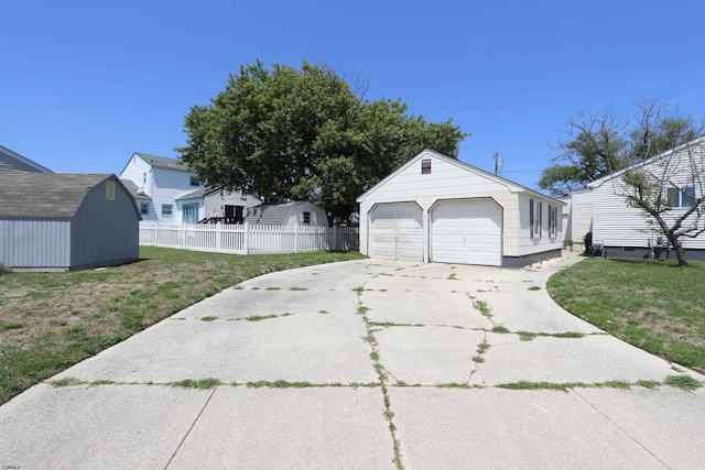 view of property exterior with a garage, a shed, and a lawn