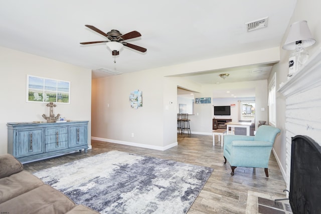 living room with ceiling fan and light wood-type flooring