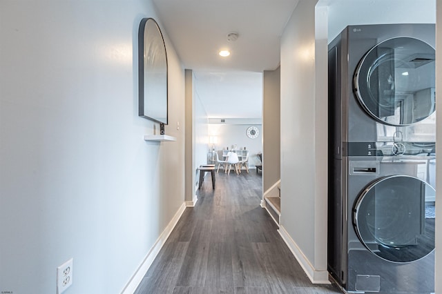 interior space with stacked washer and dryer and dark wood-type flooring