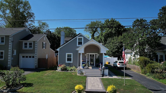 view of front of home with a garage and a front yard